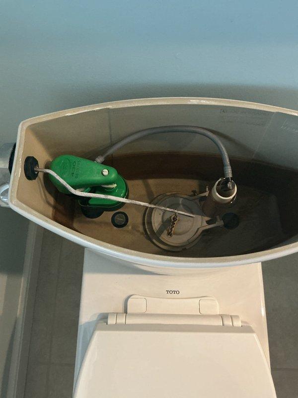 Diagnosed and repaired leaking TOTO toilet that was making noise. Inspected internal tank components, including the green float valve mechanism and flush valve assembly, and checked the water supply line and chrome shutoff valve connection. Completed necessary adjustments to eliminate leak and noise issues, restoring proper toilet operation.