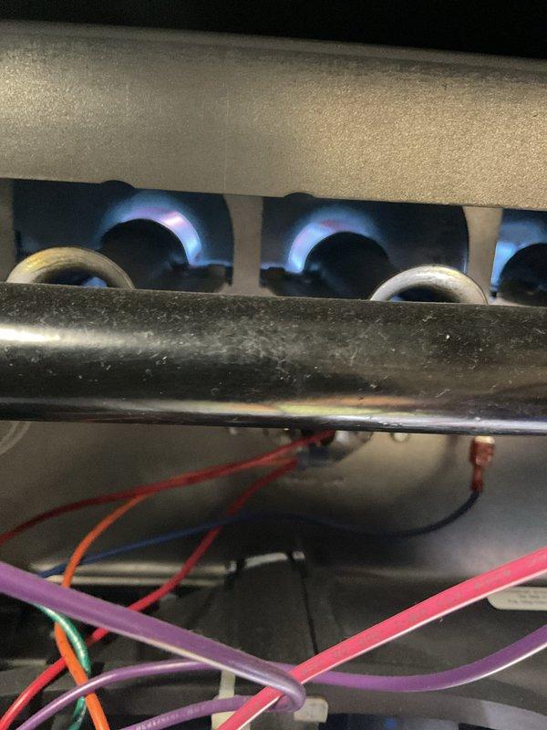 Performed Gold Furnace Inspection on operational furnace under 10 years old located in basement. Inspected igniter/sensor probe and verified proper electrical connections. Observed burner assembly with clean blue flame pattern indicating correct combustion and proper system operation.