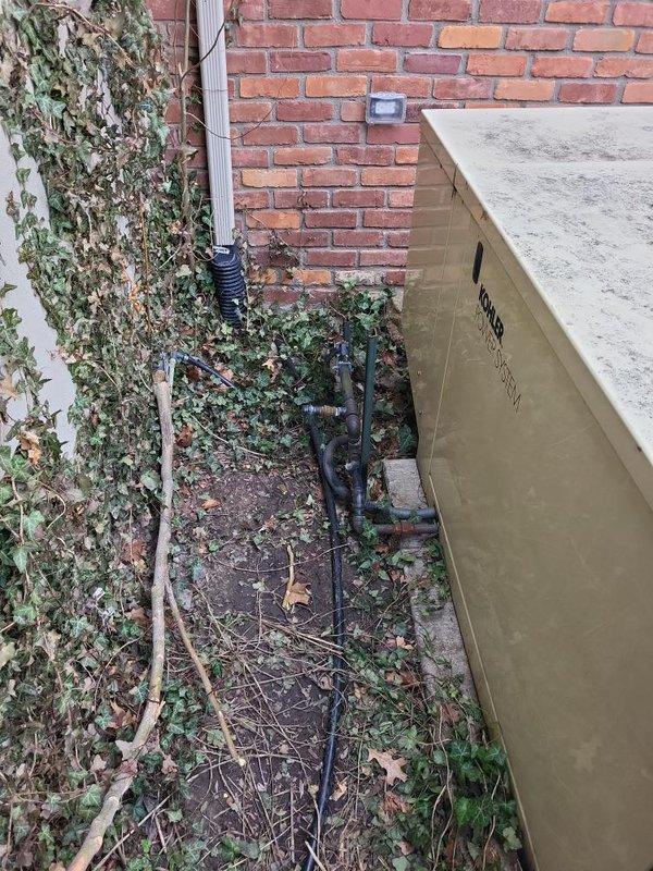 Performed evaluation for replacement of existing whole home generator system. Inspected current Kohler Power System Transfer Switch installation and associated electrical panels mounted on concrete block wall. Assessed exterior conduit routing and connection points between generator location and main electrical system. Documented current configuration for proper replacement specifications and sizing requirements.