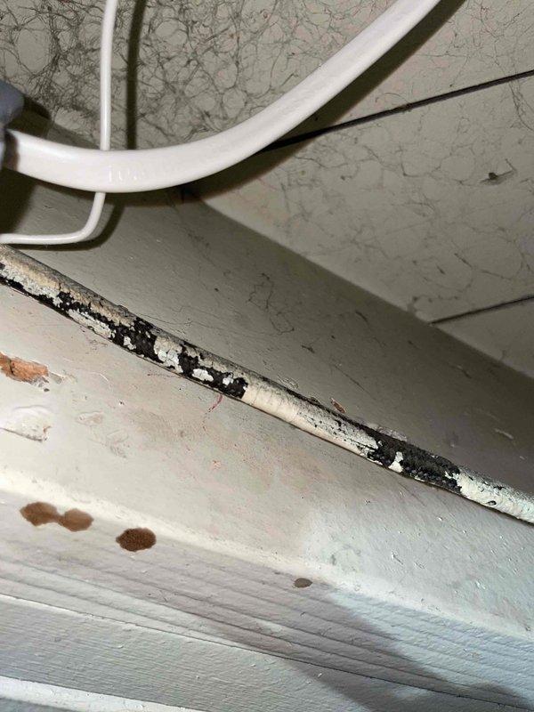 Provided estimate for replacement of 10+ year old AC unit and hot water tank located in basement. Current equipment is operational but showing signs of aging. Inspection revealed moisture damage around plumbing connections with visible water staining on walls, deterioration of trim with black mold presence, and potential water leakage affecting the surrounding infrastructure. Natural gas is available for replacement equipment.