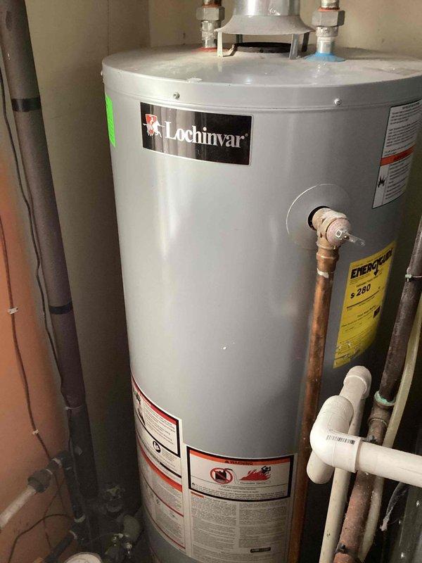 Performed assessment for converting existing Lochinvar tank water heater system to tankless hot water heater as requested by customer. Current tank unit is non-operational. Evaluated existing plumbing configuration including copper supply lines, ventilation requirements, and available utility connections to determine feasibility of tankless installation.