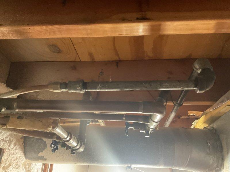 Successfully removed gas line to dryer in laundry room of 56-year-old residential property. Inspection of plumbing infrastructure revealed multiple copper and galvanized steel pipes with functioning brass shutoff valve in good condition. No significant corrosion or damage was observed in the existing piping system.