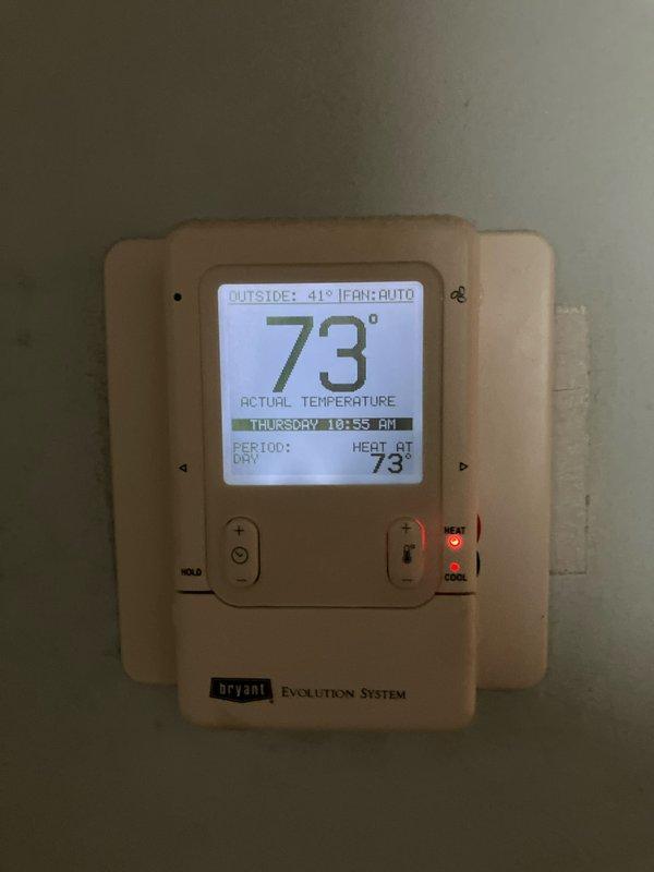 Conducted inspection of 16-year-old furnace system exhibiting abnormal inducer motor noise, poor overall performance, and a failed secondary heat exchanger with visible corrosion and rust damage. Also evaluated existing AC unit and humidifier for potential replacement. Documented exterior conditions including drainage/ventilation components and verified current system operation via Bryant Evolution thermostat.