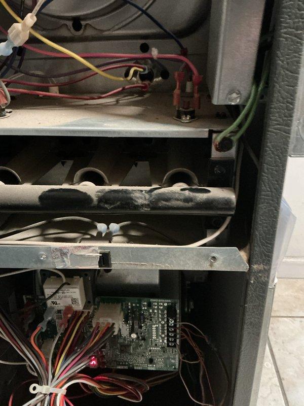 Responded to no-heat call for furnace displaying fault code. Inspected internal components including circuit board with illuminated red indicator light, heat exchanger, and wiring connections. Diagnosed and repaired faulty control board causing system failure, restoring proper heating operation.