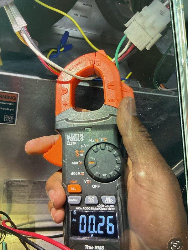 Responded to service call for a 2-year-old furnace reported with incorrect power interrupt installation, failing inducer motor, and leak. Inspection confirmed inducer motor drawing 0.26 amps, which is below normal operational parameters. Visual examination revealed significant corrosion and rust on internal components, consistent with reported leak issue. Documented findings with detailed photos of affected components and electrical measurements for service record.