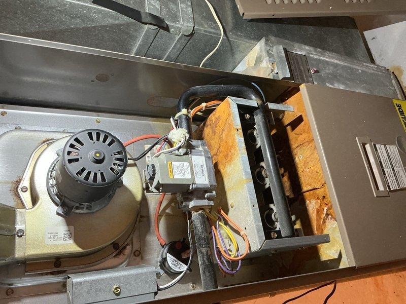 Responded to service call for a 10-year-old furnace continuously running. Diagnostic inspection revealed significant corrosion on the control board and heat exchanger, with visible oxidation on multiple components. Replaced faulty circuit board which was preventing proper cycling, restoring normal operation of the heating system.