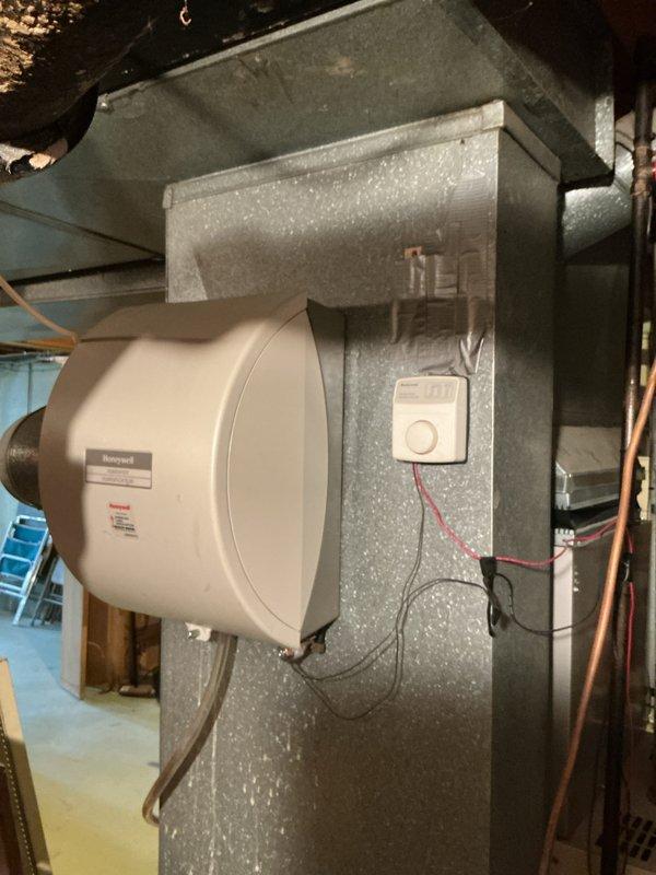 Inspected 30-year-old furnace in basement that was not heating due to failed heat exchanger and high limit switch. Documented existing HVAC system including Honeywell humidifier attachment and assessed condition of ductwork, wiring, and copper lines. Provided estimate for complete furnace replacement with options for AC and humidifier replacement.