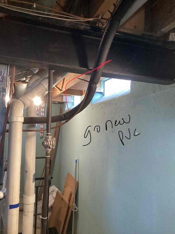 Conducted diagnostic assessment on 20-year-old leaking furnace located in basement. Inspection revealed aging galvanized ductwork with vibration isolation connections and handwritten measurements (12" and 10½") marked on the metal surfaces. Recommended full replacement due to equipment age and condition, with new PVC venting as indicated by existing utility area markings.