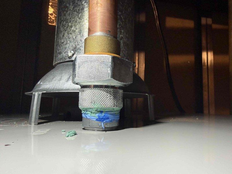 Responded to callback for newly installed 40-gallon water heater exhibiting significant leakage. Inspection revealed improper sealing at threaded pipe connection with evidence of pipe compound failure. Repaired connection, verified proper operation, and documented with photos of the affected plumbing assembly and installation area.