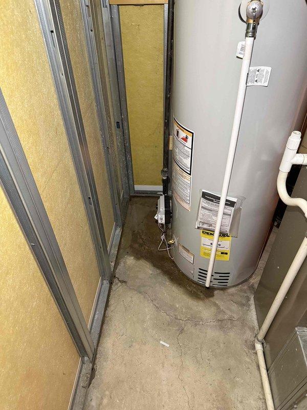 Responded to callback for newly installed 40-gallon water heater exhibiting significant leakage. Inspection revealed improper sealing at threaded pipe connection with evidence of pipe compound failure. Repaired connection, verified proper operation, and documented with photos of the affected plumbing assembly and installation area.
