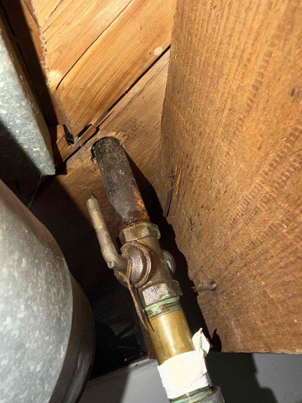 Responded to service call for gas leak at brass pipe elbow connection leading from basement to main floor gas stove. Performed diagnostic assessment of the leaking joint where pipe connects to shut-off valve, which showed signs of corrosion and aging. Replaced damaged elbow fitting and properly sealed connection to restore gas system integrity and eliminate leak hazard.