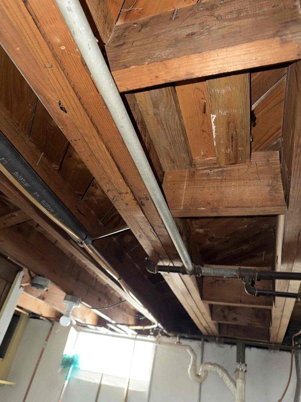 Responded to service call for gas leak at brass pipe elbow connection leading from basement to main floor gas stove. Performed diagnostic assessment of the leaking joint where pipe connects to shut-off valve, which showed signs of corrosion and aging. Replaced damaged elbow fitting and properly sealed connection to restore gas system integrity and eliminate leak hazard.