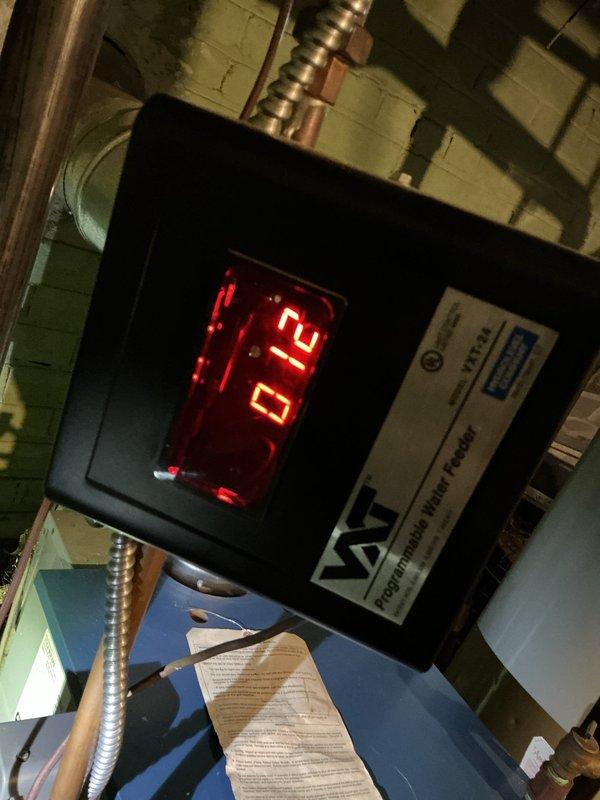 Responded to callback regarding furnace that randomly shuts off and requires manual restart. Inspected boiler system in basement and found fault with the Precision Water Feeder control displaying error code "12", indicating improper water level regulation. Verified wiring connections at junction box, reset control module, and restored proper operation of the 10+ year old system.