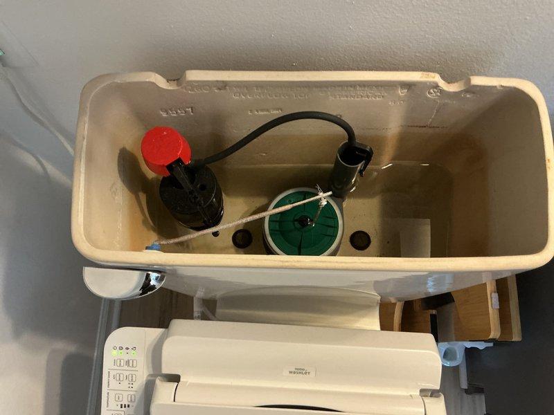 Diagnosed and serviced toilet with slow filling issue. Inspected internal tank components, finding mineral deposits restricting water flow. Cleaned fill valve assembly and adjusted water level to restore proper filling function. Verified normal operation through multiple test flushes.