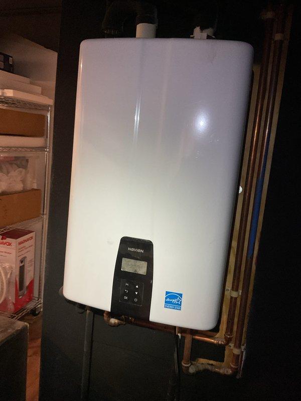 Completed Gold Furnace Inspection on 11-year-old Bryant forced air system located in basement. Unit is functioning properly with no visible damage or unusual wear. Also noted presence of Navien tankless water heater with Energy Star certification in good working condition with proper venting and plumbing connections.