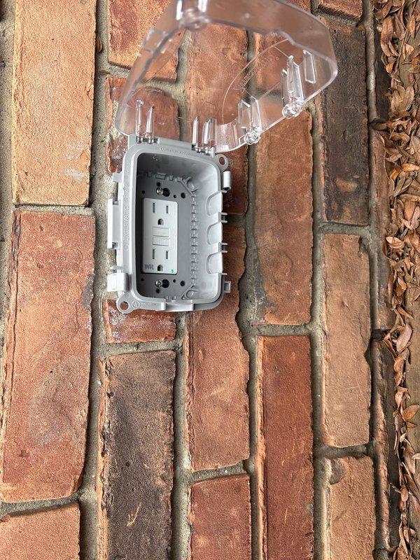 Diagnosed outdoor GFCI outlet that was reported non-functional. Inspected weatherproof housing and found the GFCI had tripped internally despite breaker remaining on. Reset GFCI receptacle, tested functionality, and verified proper operation of weatherproof cover to ensure continued protection from elements.