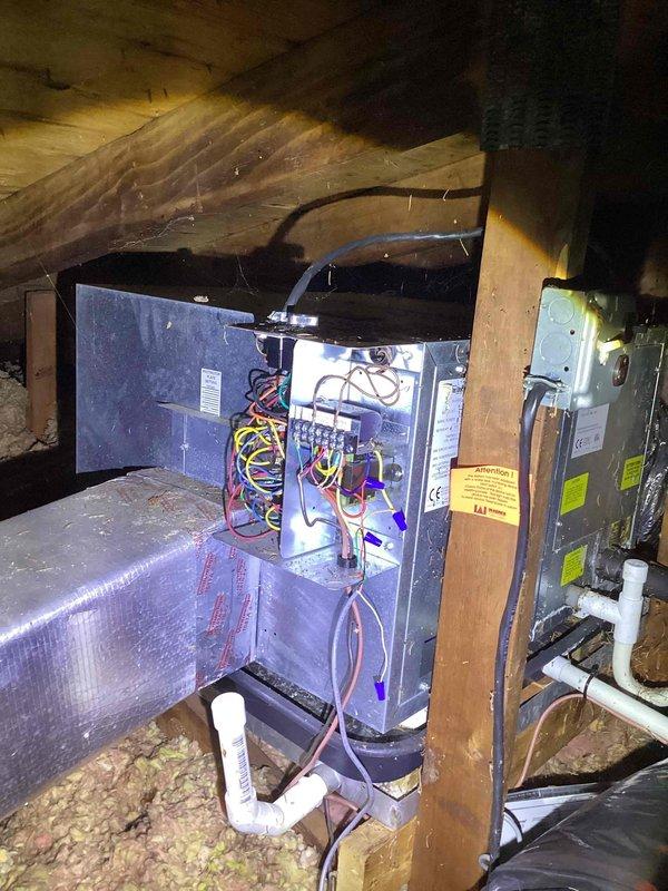 Conducted evaluation of 20-year-old HVAC system in attic showing refrigerant leak. Documented existing installation conditions including electrical connections, ductwork configuration, and limited attic access that will require special consideration during replacement. System currently operational but recommended replacement due to age and leak issues rather than repair.