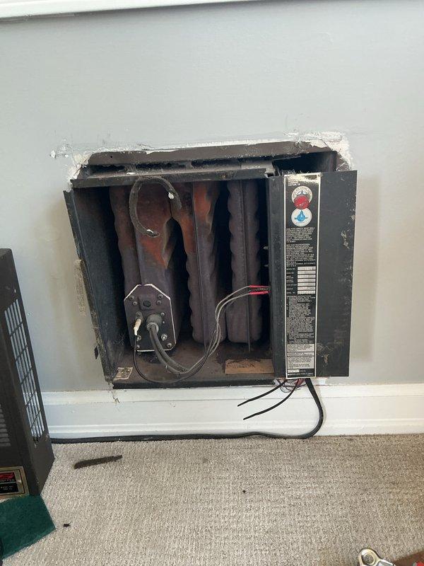 Conducted an estimate to replace an aging wall heater (circa 1997) with a mini-split system in customer's four seasons room. Inspection revealed significant dark rust on the heat exchanger and an R-22 AC system. The existing unit is failing to turn on properly and has deteriorated beyond reasonable repair, making replacement the recommended course of action.