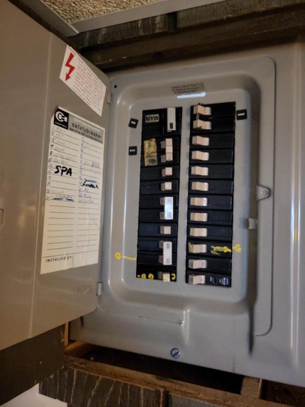 Conducted a comprehensive assessment of the existing electrical service panel for generator installation compatibility. Inspected the main breaker panel containing dual columns of circuit breakers with various load designations, including a dedicated SPA circuit. Evaluated the adjacent sub-panel and current wiring configuration to determine appropriate tie-in points for the proposed generator system.