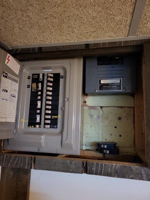 Conducted a comprehensive assessment of the existing electrical service panel for generator installation compatibility. Inspected the main breaker panel containing dual columns of circuit breakers with various load designations, including a dedicated SPA circuit. Evaluated the adjacent sub-panel and current wiring configuration to determine appropriate tie-in points for the proposed generator system.
