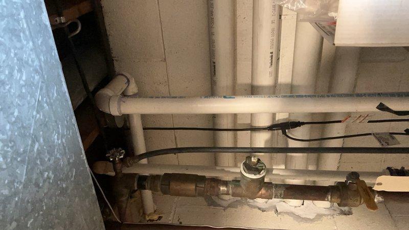 Diagnosed and replaced malfunctioning primary sump pump system that was causing backup pump activation. Observed significant mineral buildup and corrosion on pump components with sediment accumulation in basin. Additionally, repaired stuck faucet handle and addressed leaking toilet issue during service call.