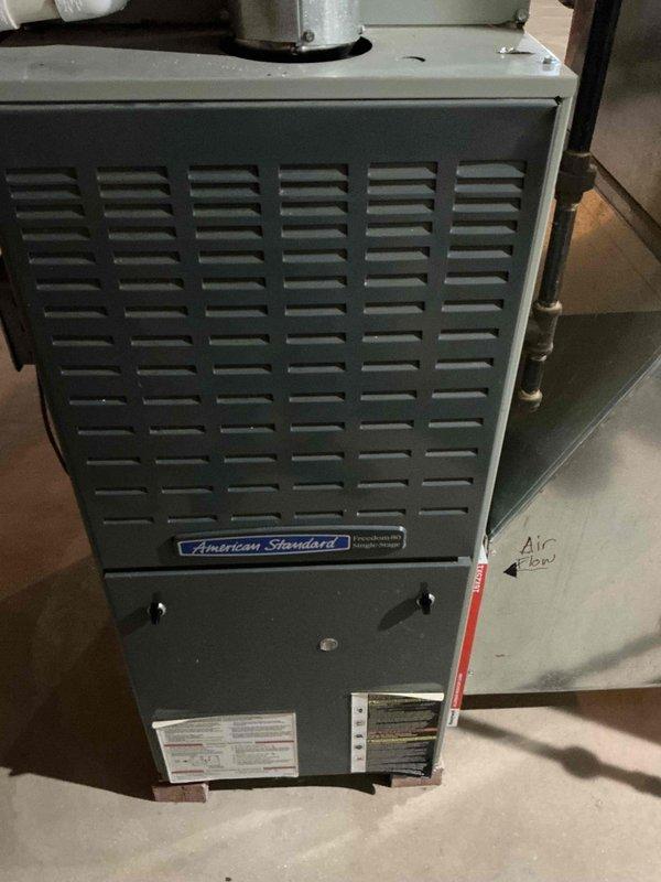 Performed Gold Furnace Inspection on 2006 American Standard furnace located in basement. Inspected blower motor, gas valve, and electrical connections, finding all components in normal working condition with no visible damage, excessive corrosion, or mechanical anomalies. System is operating properly with proper airflow and no immediate service concerns identified.