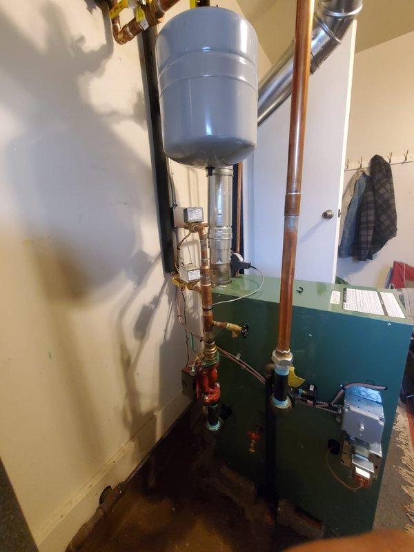 Responded to callback for newly installed boiler system struggling to maintain temperature above 69°F. Inspected burner assembly and flame pattern, finding proper ignition but inadequate heat transfer. Adjusted control parameters and verified proper function of expansion tank and copper supply lines, resulting in improved heating performance to meet customer's comfort requirements.