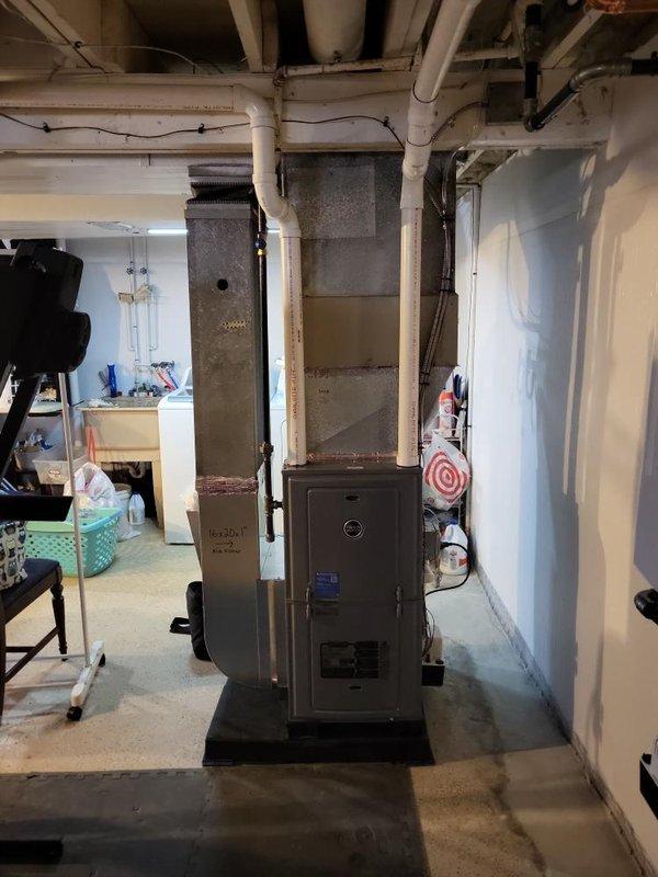 Performed assessment of 10+ year old AC unit for potential replacement. System is currently operational but aging. Conducted thorough inspection of existing HVAC setup including furnace in basement utility area and electrical panel to determine compatibility requirements for replacement options. Natural gas furnace with standard ductwork configuration was documented to prepare appropriate replacement estimate.