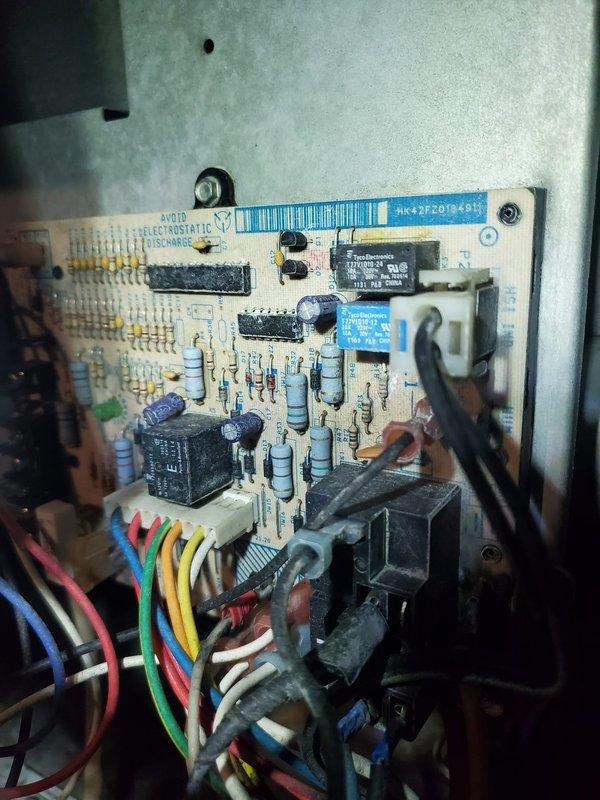 # HVAC Service Report - Furnace Repair

Responded to service call for furnace failure with no heat condition. Upon arrival, observed pressure switch sensor fault indicated by flashing diagnostic light on control board. Performed system diagnostics and confirmed control board malfunction preventing ignition sequence. Documented existing equipment configuration including water heater and furnace installation in mechanical room with photos of failed control board showing multiple relays and electronic components. Replacement control board was retrieved from shop inventory and installed to restore furnace operation and resolve no-heat condition.