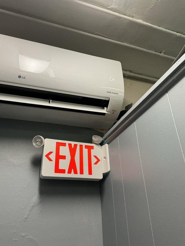 # Service Summary

Ordered replacement parts for commercial mini-split system under PO 1297775-001 with 4-7 business day lead time from Young Supply Troy. Documented electrical panel configuration and LG DUAL Inverter mini-split unit installation for service records.

# Work Performed

Responded to service call for commercial LG DUAL Inverter mini-split air conditioning system. Conducted diagnostic evaluation of the ductless heating and cooling unit mounted in the commercial space. Upon inspection, identified component failure requiring replacement parts.

Coordinated parts procurement through Young Supply Troy and generated purchase order 1297775-001 for necessary components. Confirmed parts availability with supplier, noting 4-7 business day lead time for delivery. Documented electrical distribution system serving the mini-split unit, including Square D brand circuit breaker panel rated at 125 AMP maximum capacity operating at 120/240V single-phase and 240V three-phase configurations