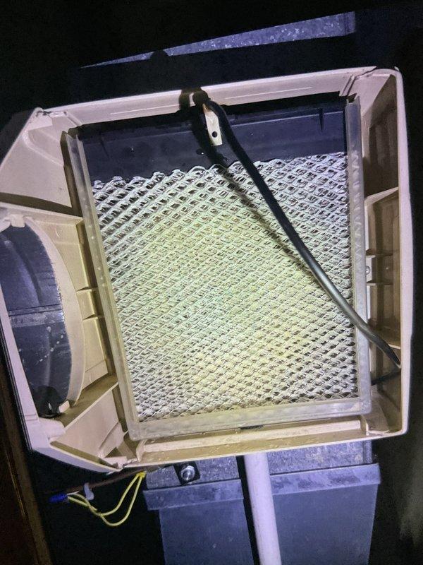 # HVAC Service Report

Performed comprehensive furnace tune-up service on gas-fired heating unit located in basement. Conducted thorough system inspection, cleaning, and maintenance procedures to ensure optimal performance and safety for the upcoming heating season.

## Work Performed

Accessed furnace cabinet and inspected all internal components for wear, damage, and proper operation. Removed and cleaned blower assembly, removing accumulated dust and debris from blower wheel and housing. Inspected heat exchanger for cracks, corrosion, or signs of failure using visual inspection methods.

Examined and serviced air filtration system. Documented existing filter condition, which showed significant dust accumulation and discoloration across mesh surface, indicating extended use period. Inspected filter housing assembly, including hinged access door, frame mounting, and sealing surfaces to ensure proper fit and air bypass prevention.

Cleaned burner assembly and inspected burner flames for