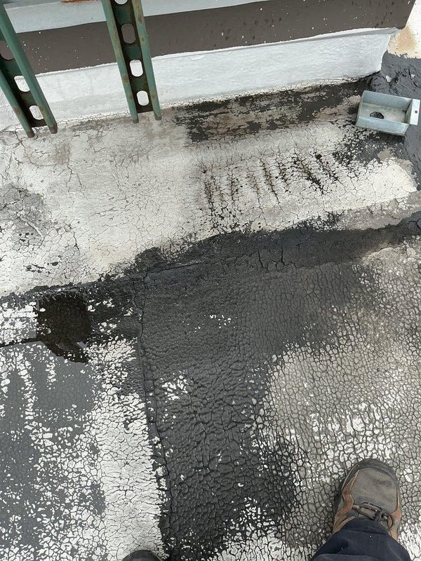 # Service Report: Water Leak Repair - Commercial Rooftop

Responded to water leak complaint affecting office space below. Upon inspection, identified compromised waterproofing membrane on commercial flat roof as source of intrusion. Applied waterproofing coating to affected areas of roof surface, ensuring proper coverage and sealing of penetration points. Treated approximately 200 square feet of roofing substrate with rolled-on waterproofing compound, paying particular attention to areas around rooftop penetrations including ventilation stack and parapet transitions. Verified proper drainage patterns and confirmed no standing water remained after application. Leak source eliminated and waterproofing membrane restored to prevent future water intrusion into office space.