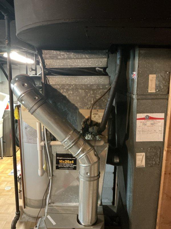 # HVAC Estimate - Full System

Conducted comprehensive assessment of existing residential HVAC system in basement utility area to provide full system replacement quote. Evaluated current Amana furnace installation and associated air handler equipment, documenting existing ductwork configuration including metallic ventilation ducts and gray insulated distribution system. Inspected air handler cabinet, examined system specifications and warning labels, and assessed 16x25x4 filter housing integration. Photographed complete mechanical room layout including furnace unit with visible manufacturer branding and ENERGYGUIDE efficiency labels, horizontal duct connections, and surrounding infrastructure. Reviewed customer's request for new air conditioning system options and discussed available warranty programs to meet their comfort and protection needs. Documented basement mechanical space conditions, existing equipment placement, and ductwork routing to prepare accurate proposal for complete H