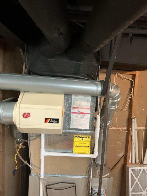 # HVAC Estimate - Full System

Conducted comprehensive assessment of existing residential HVAC system in basement utility area to provide full system replacement quote. Evaluated current Amana furnace installation and associated air handler equipment, documenting existing ductwork configuration including metallic ventilation ducts and gray insulated distribution system. Inspected air handler cabinet, examined system specifications and warning labels, and assessed 16x25x4 filter housing integration. Photographed complete mechanical room layout including furnace unit with visible manufacturer branding and ENERGYGUIDE efficiency labels, horizontal duct connections, and surrounding infrastructure. Reviewed customer's request for new air conditioning system options and discussed available warranty programs to meet their comfort and protection needs. Documented basement mechanical space conditions, existing equipment placement, and ductwork routing to prepare accurate proposal for complete H