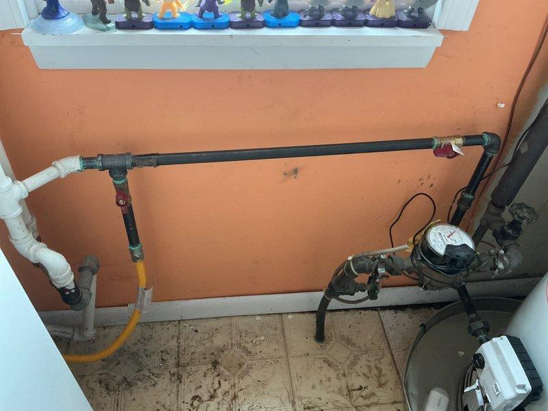 # Plumbing Install - Tanked Water Heater

## Job Description

Completed installation of a Bradford White tanked water heater unit in basement utility area. Installed new water heater with proper venting system, including segmented metallic vent pipe secured with metal clamps and routed at appropriate angle for safe exhaust. Connected copper supply lines to unit with dielectric unions at connection points to prevent galvanic corrosion. Installed shut-off valve with accessible handle for service and emergency shutoff capability. Verified all plumbing connections for proper fit and leak-free operation. System tested and confirmed operational upon completion of installation.