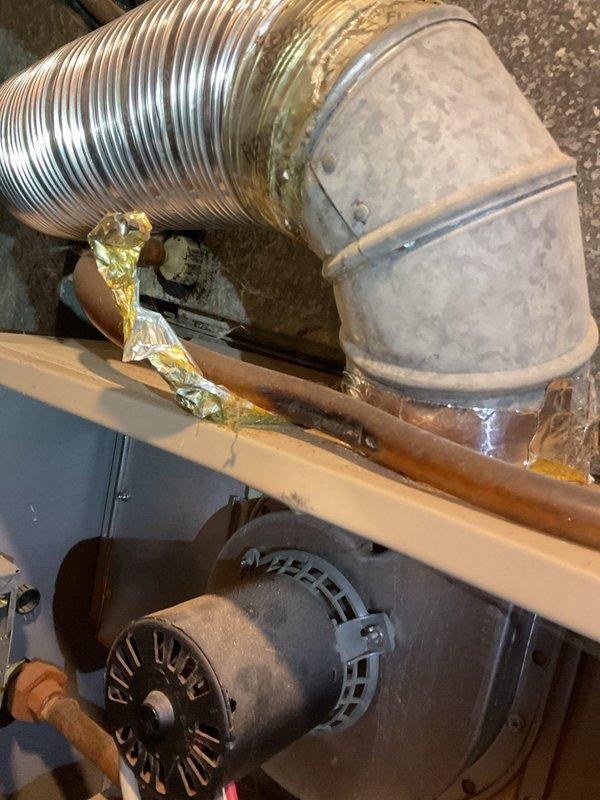 # HVAC Service Report - Furnace Repair

Responded to service call for furnace blowing cold air in basement location. Upon arrival, performed diagnostic evaluation of heating system over 10 years old. Inspection revealed inducer motor assembly issues affecting proper furnace operation. Examined FASCO blower motor unit and associated ductwork connections, noting dust accumulation and age-related wear on components. Assessed flexible metallic supply duct connections and elbow joints showing signs of deterioration.

Investigated gas supply line and associated plumbing connections, identifying corrosion on brass fittings and copper piping that required attention. Evaluated braided flex line connections and verified secure mounting of all gas line components to ensure safe operation. Addressed compromised duct sealing material and metallic tape deterioration affecting system efficiency. Performed necessary adjustments to restore proper airflow and heating function. System tested and confirme