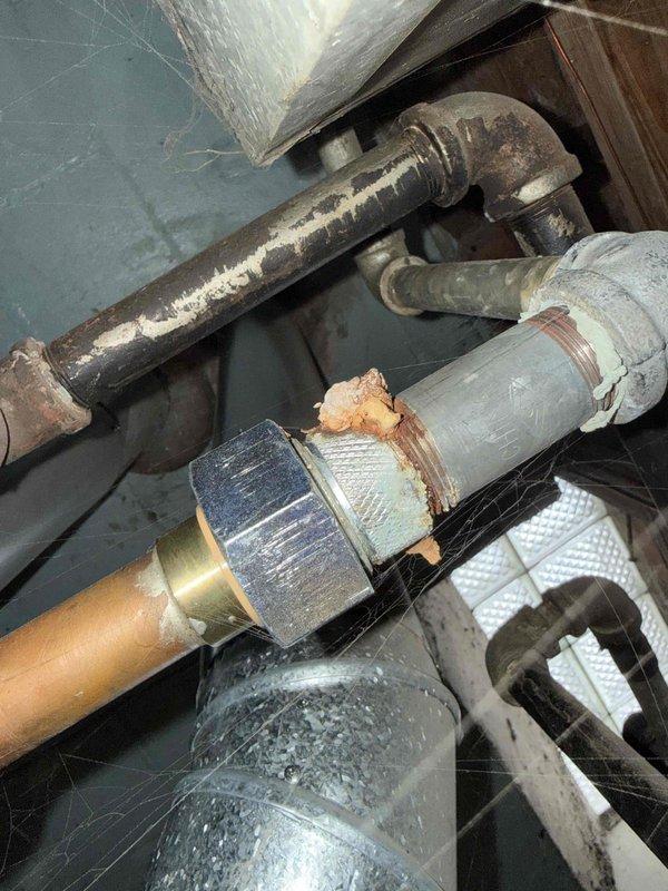 # HVAC Service Report - Furnace Repair

Responded to service call for furnace blowing cold air in basement location. Upon arrival, performed diagnostic evaluation of heating system over 10 years old. Inspection revealed inducer motor assembly issues affecting proper furnace operation. Examined FASCO blower motor unit and associated ductwork connections, noting dust accumulation and age-related wear on components. Assessed flexible metallic supply duct connections and elbow joints showing signs of deterioration.

Investigated gas supply line and associated plumbing connections, identifying corrosion on brass fittings and copper piping that required attention. Evaluated braided flex line connections and verified secure mounting of all gas line components to ensure safe operation. Addressed compromised duct sealing material and metallic tape deterioration affecting system efficiency. Performed necessary adjustments to restore proper airflow and heating function. System tested and confirme