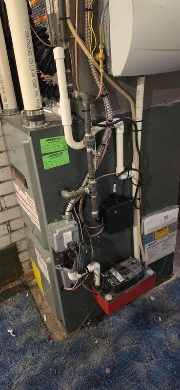 # HVAC Install - A/C & Coil Completion Summary

Successfully installed a complete 1.5-ton air conditioning system including a new Lennox condensing unit and matching evaporator coil. The outdoor condenser was positioned on a composite pad over concrete surface with proper clearances, while the indoor coil was integrated with the existing air handler in the basement utility area. All refrigerant lines, condensate drainage via PVC piping, and electrical disconnects were properly installed per manufacturer specifications, though a licensed electrician is required to complete the new dedicated circuit as noted in the permit requirements.