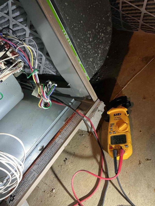 # HVAC Service Warranty Report

## Service Summary
Responded to no-heat complaint on 5-year-old furnace producing operational sounds without heat output. Diagnosed failed blower motor and completed replacement under warranty.

## Work Performed

Arrived on-site and confirmed homeowner complaint of furnace running without heat production. Conducted comprehensive diagnostic evaluation of basement-installed furnace system. Performed visual inspection of unit components and verified power supply to system.

Utilized digital multimeter to test electrical circuits and components. Measured voltage and continuity across heating elements and motor connections. Testing revealed blower motor failure as root cause of no-heat condition. Motor was receiving proper electrical supply but failed to operate, preventing air circulation through heat exchanger and resulting in no heat delivery to living spaces.

Documented equipment specifications and wiring configuration through photographic documentation