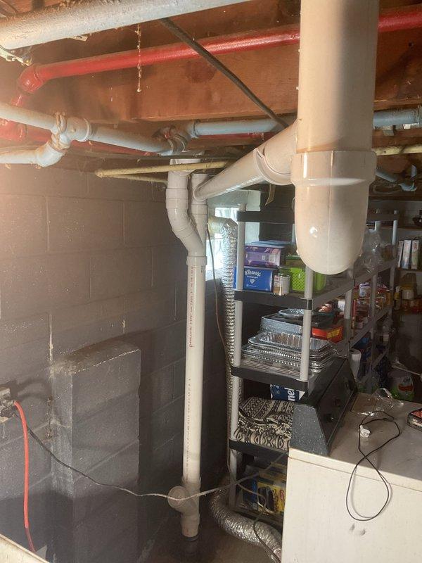 # Plumbing Service Report

Completed stack repair service in residential property. Replaced and reconfigured white PVC drain stack assembly in basement utility area, including multiple fittings and curved sections to ensure proper drainage flow. Connected flexible corrugated drain hose to new stack system and verified all connections were secure and leak-free. Work performed in area with existing PEX water lines and electrical infrastructure. All plumbing work completed to code specifications and system tested for proper operation.