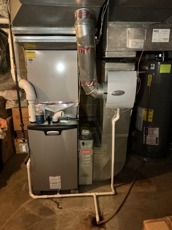 # HVAC Maintenance - Prepaid Visit Summary

Completed comprehensive furnace inspection on 1-year-old residential heating system located in basement. Verified unit operational status and conducted thorough evaluation of all system components including furnace, air handler, and associated ductwork. Inspected system for reported leakage concerns, examining condensate drainage system, PVC piping connections, and trap assembly. Performed electrical diagnostics using clamp meter to verify proper amperage draw and system performance. Documented equipment configuration including Aprilaire accessory component and metallic ductwork with flex connections. All safety labels and manufacturer specifications verified present and legible. System found operational with inspection findings documented photographically for service records.