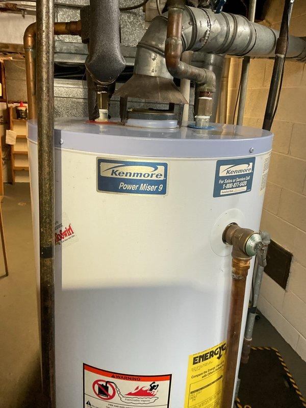 # Service Report

Completed city rental certification inspection on 20-year-old furnace system located in basement. Performed comprehensive tune-up inspection including furnace operational checks, thermostat calibration verification, humidifier assessment, and hot water tank inspection per certification requirements. Documented Kenmore Power Miser 9 water heater condition with visible copper supply lines, brass drain valve, and proper venting configuration. Inspected HVAC unit showing normal wear patterns consistent with age, verified all safety controls operational, and confirmed system meets municipal code requirements for rental property certification. Tagged unit as required for city compliance documentation.