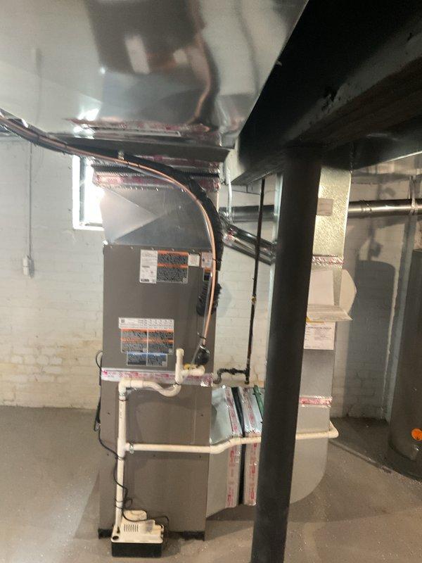 # HVAC Install - A/C & Coil Service Report

Successfully completed full-day installation of 2.5-ton air conditioning system with evaporator coil and furnace reinstallation in residential basement utility area. Installation included new copper refrigerant lines with proper insulation, white PVC condensate drainage system with pump, and coordination with electrician for new dedicated circuit as specified. All mechanical and electrical permits were requested and processed, with equipment properly positioned on concrete floor against concrete block walls, refrigerant lines routed to ceiling, and all connections secured per manufacturer specifications and code requirements.
