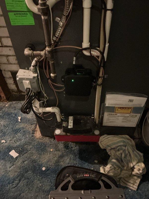 Returned to complete condensate pump replacement on 1.5 ton A/C system with new coil installation. Completed pump installation and verified proper operation with green indicator light illuminated. Addressed customer concern regarding furnace not operating properly since initial installation; inspected burner assembly, blower motor, and electrical connections to diagnose and resolve heating system malfunction.