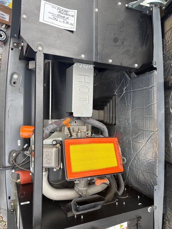 Performed routine maintenance on a 16KW Honeywell standby generator. Inspected air filter, fuel delivery system components, and control panel functionality. Verified SYNC 2.0 controller display showing proper battery condition, confirmed AUTO/MANUAL selector operation, and documented all safety systems operational with unit running normally.