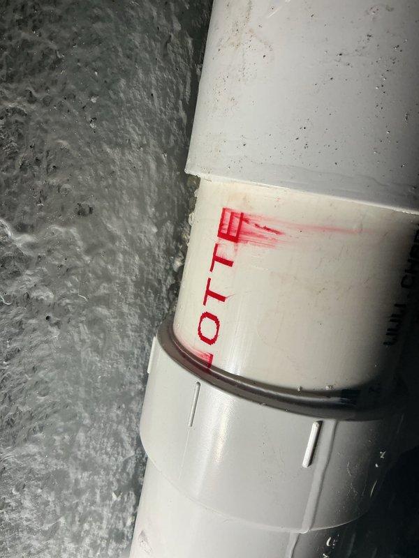 Responded to callback for ongoing water leak at previously repaired PVC drainage piping. Upon inspection, identified active leak at vertical pipe coupling joint where recent repair had been attempted. Disassembled existing coupling connection, cleaned and prepped pipe surfaces, and reinstalled joint using proper PVC primer and cement application techniques to ensure watertight seal. Verified all connections were secure and tested system for proper drainage and leak elimination.