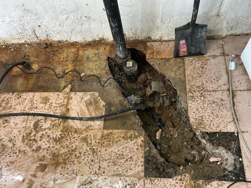 Completed hot water heater reconnection in mechanical room following significant water damage remediation. Addressed extensive floor deterioration, mold growth, and standing water contamination around plumbing penetrations in basement utility area. Reconnected water heater system after clearing sediment accumulation and verifying proper drainage function through exterior access points and underground infrastructure components.