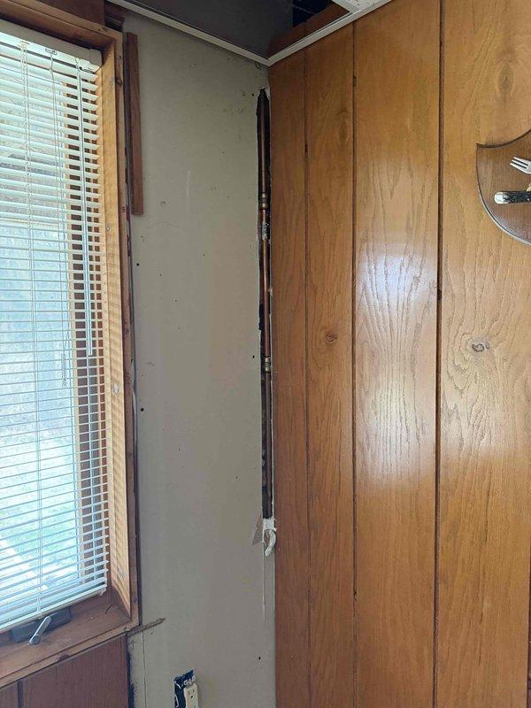 Completed installation of a 40-gallon standard Bradford White water heater in basement utility area. Installed new unit with proper venting through black exhaust pipe routed to ceiling, connected all water supply lines and gas connections, and verified proper operation of gas control valve and all safety features.