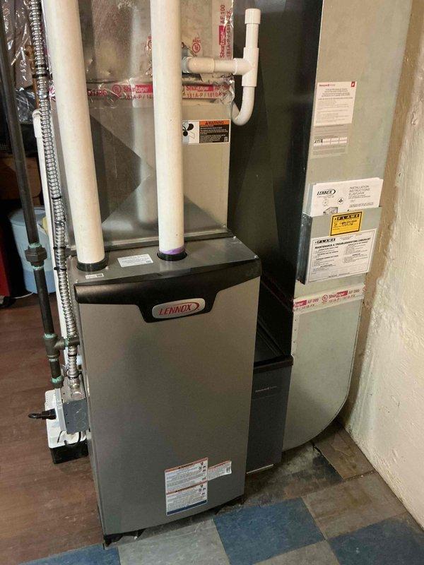 Successfully completed installation of a Lennox 70,000 BTU gas furnace in basement location, including all mechanical and electrical connections. Installation included proper venting with PVC intake and exhaust piping, flue liner installation, condensate drainage system with pump, and reconnection of existing ductwork to new unit. All components tested and system operational upon completion.