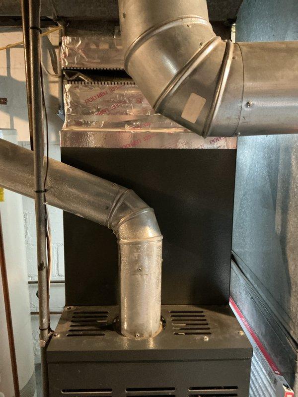 Completed furnace replacement estimate for a 15-year-old heating system experiencing multiple component failures. Upon inspection, identified blower motor seizing intermittently, inducer motor with active leak, burnt wiring on inducer assembly, and deteriorated humidifier pad requiring replacement. Unit located in basement with exposed ductwork and standard galvanized metal connections. Documented existing HVAC installation including vertical and horizontal duct transitions, copper piping, and overall system configuration. Provided comprehensive assessment of aging equipment and recommended replacement options due to cumulative component wear and intermittent operation affecting system reliability.